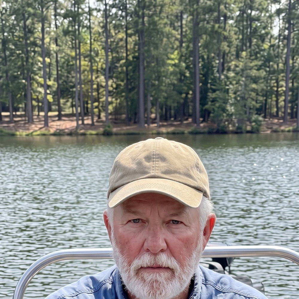 Angler with a bass wearing a regular cap